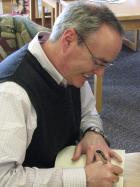 Terry Fallis Signing "The High Road" for a Pelham Public Library Patron
